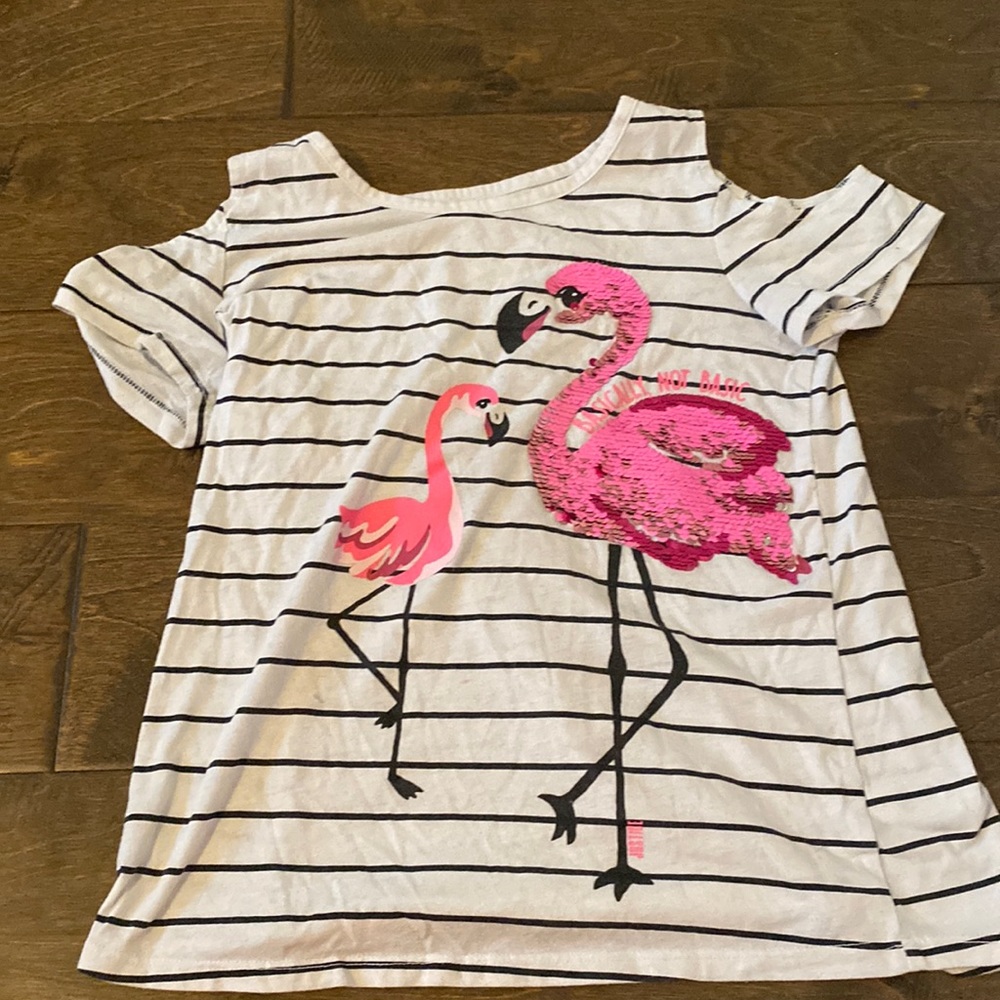 I am selling a striped shirt that has a flamingo on it.